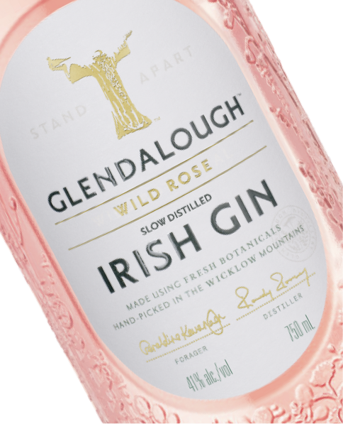 A close-up, angled view of the label on a bottle of Glendalough Wild Rose Irish Gin.